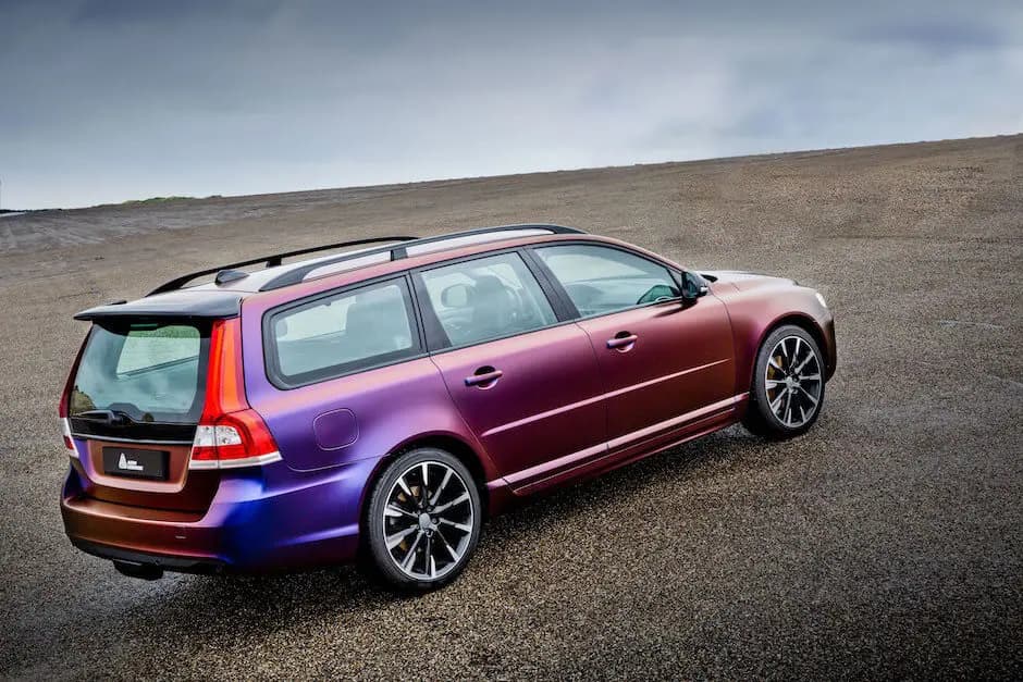 Rear three-quarter view of a station wagon wrapped in ColorFlow Roaring Thunder, red across the doors turning blue and violet over the rear quarter and bumper